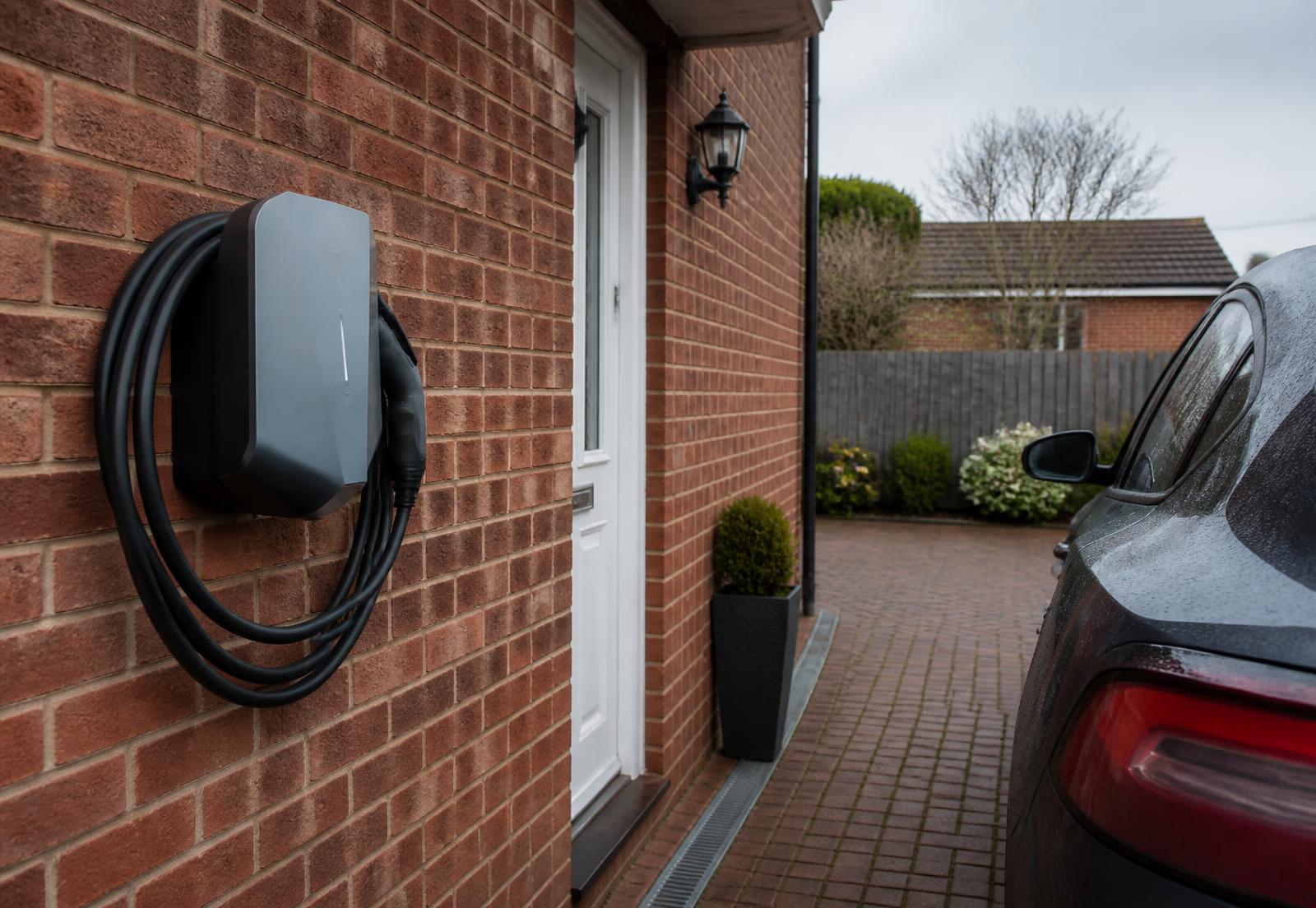 EV charger installed neatly on the brick exterior wall of a house