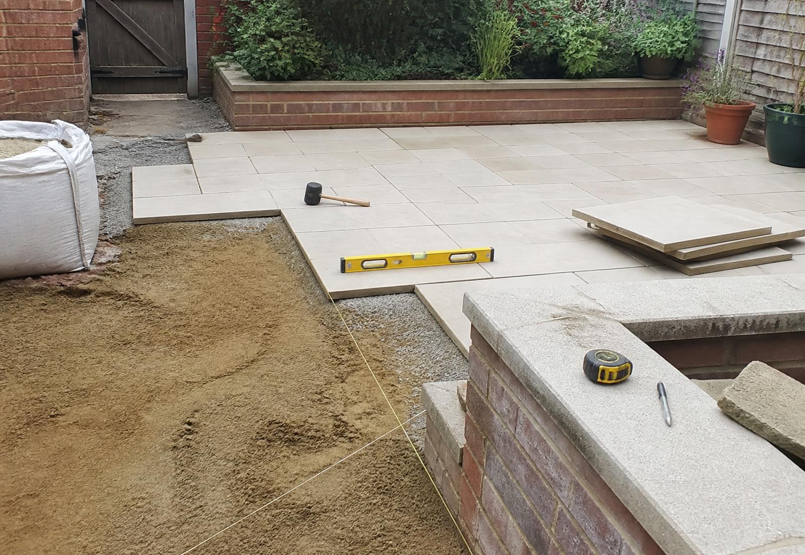 Limestone paving being set out during a garden build